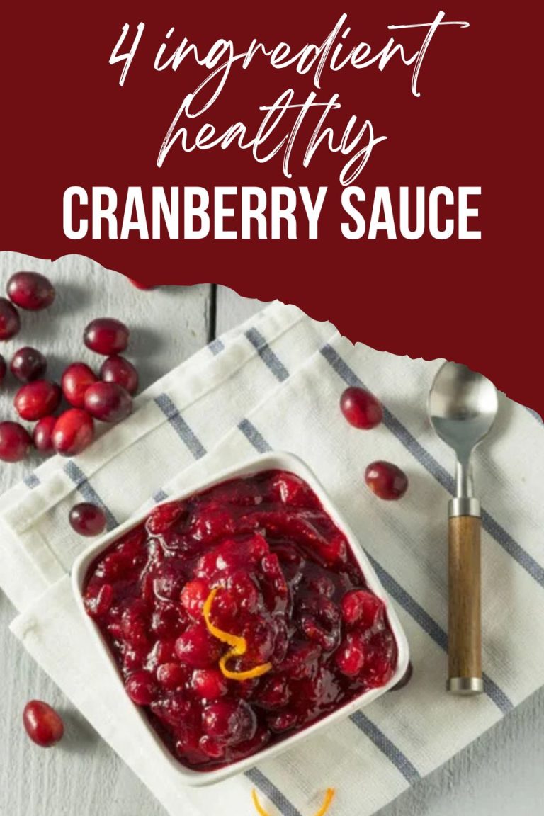 white bowl of bright burgundy cranberry sauce topped with orange zest